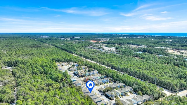 drone / aerial view featuring a wooded view