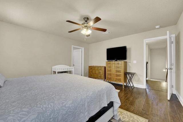 bedroom with visible vents, ceiling fan, baseboards, and wood finished floors