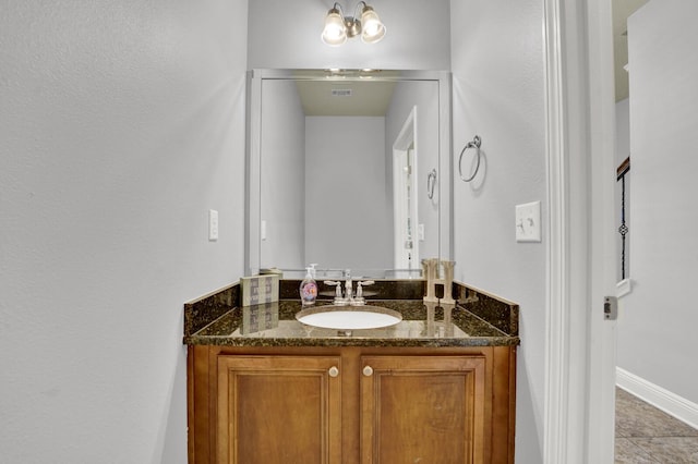 bathroom featuring baseboards and vanity