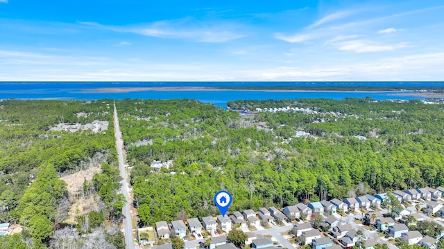 bird's eye view with a water view, a residential view, and a view of trees