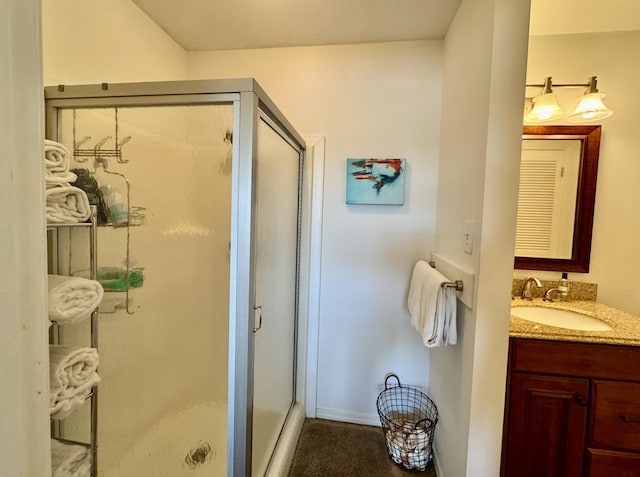 bathroom with a stall shower and vanity