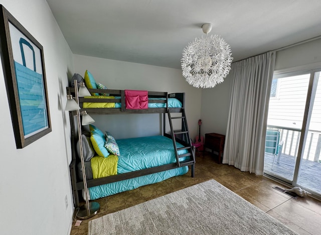 bedroom featuring tile patterned flooring, access to outside, multiple windows, and a chandelier