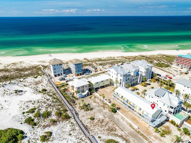 drone / aerial view with a water view and a beach view