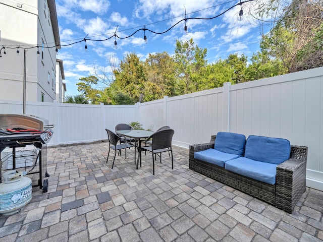 view of patio / terrace featuring a fenced backyard, area for grilling, and outdoor dining space