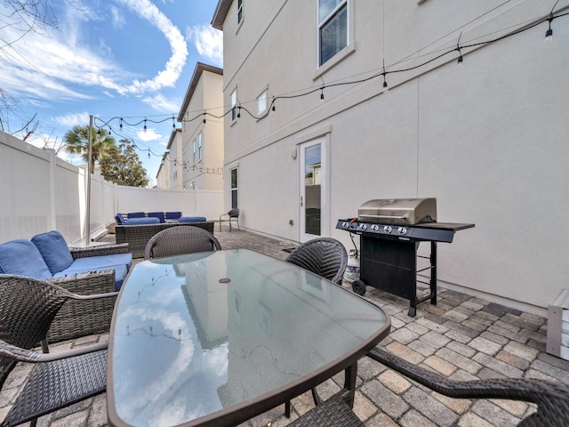 view of patio / terrace featuring a grill, an outdoor hangout area, a fenced backyard, and outdoor dining space