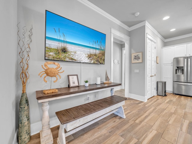 interior space featuring baseboards, light wood finished floors, recessed lighting, and crown molding