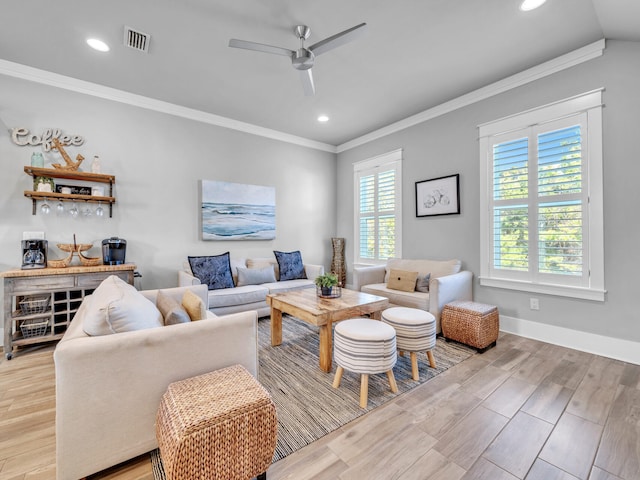 living area featuring visible vents, ceiling fan, crown molding, light wood-type flooring, and recessed lighting