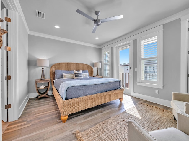 bedroom with crown molding, visible vents, wood finished floors, access to outside, and baseboards