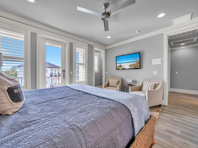 bedroom with access to outside, multiple windows, crown molding, and wood finished floors