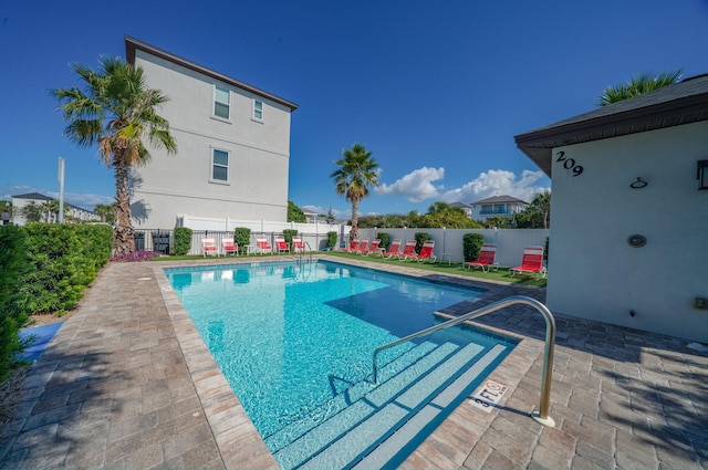 view of swimming pool with a fenced in pool, a patio area, and fence