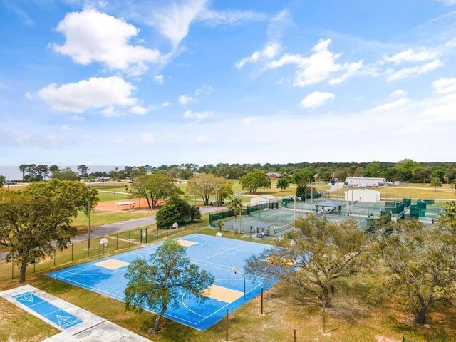 view of swimming pool with community basketball court and fence