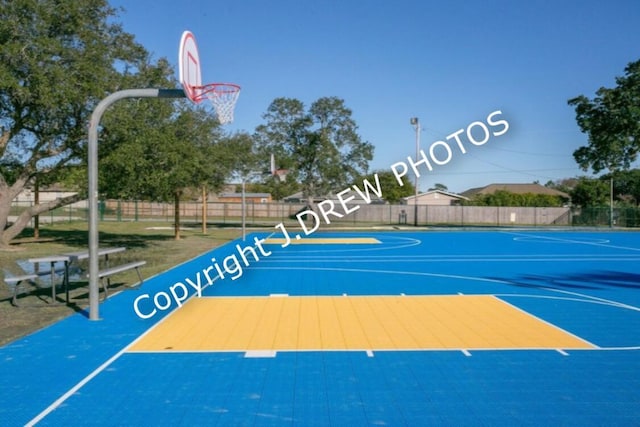 view of sport court featuring community basketball court and fence