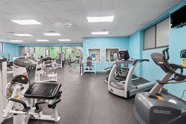 gym featuring baseboards, visible vents, and a drop ceiling