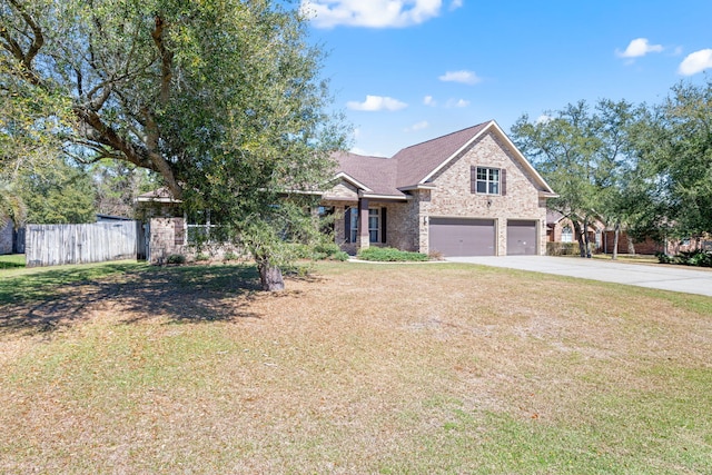 traditional home with an attached garage, a front yard, fence, stone siding, and driveway