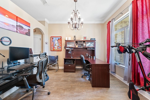 office featuring a chandelier, light wood finished floors, visible vents, and crown molding