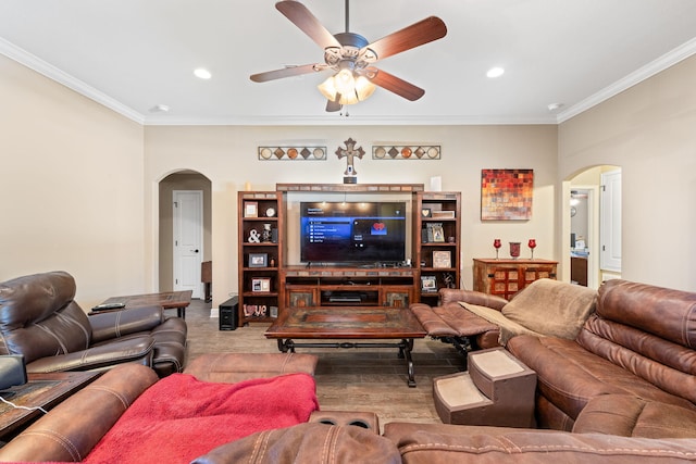 living room featuring ornamental molding, arched walkways, and recessed lighting