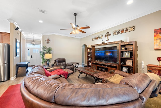 living area featuring baseboards, arched walkways, ceiling fan, crown molding, and recessed lighting