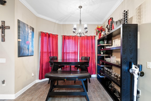 dining space featuring a notable chandelier, ornamental molding, baseboards, and wood tiled floor