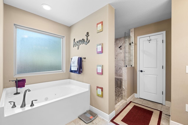 full bathroom with baseboards, a tile shower, and a tub with jets