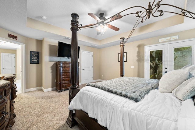 bedroom with french doors, a raised ceiling, light colored carpet, access to outside, and baseboards