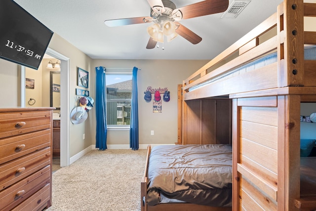 bedroom featuring light colored carpet, ceiling fan, visible vents, and baseboards