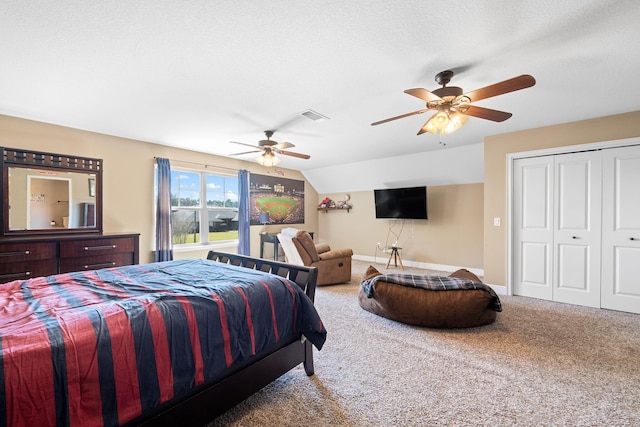 carpeted bedroom with visible vents, a ceiling fan, vaulted ceiling, a textured ceiling, and baseboards