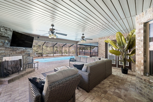 view of patio / terrace with a ceiling fan, glass enclosure, an outdoor pool, and an outdoor living space