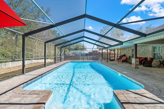 view of pool with glass enclosure, a patio area, fence, and a fenced in pool