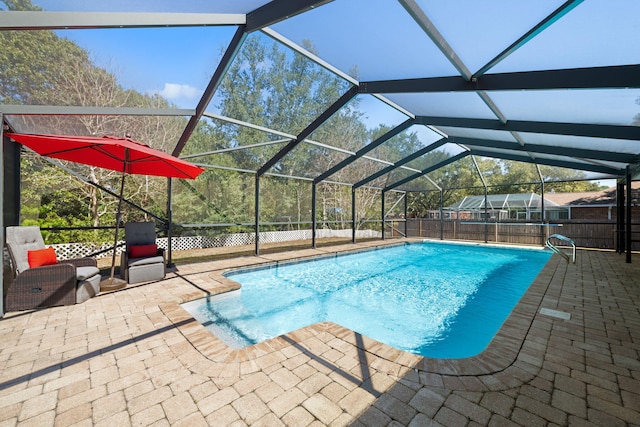 view of swimming pool featuring a lanai, fence, a fenced in pool, and a patio