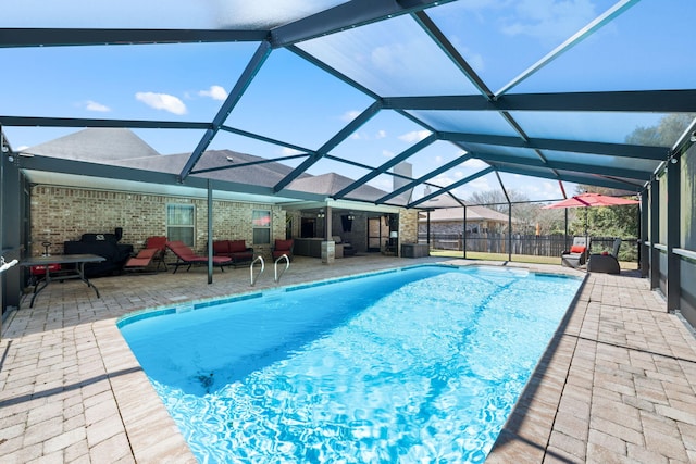 view of swimming pool with a patio area, a lanai, and a fenced in pool