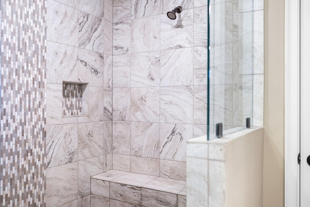 full bathroom featuring tiled shower