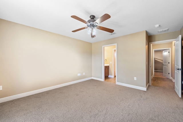 unfurnished bedroom with visible vents, connected bathroom, light carpet, and baseboards