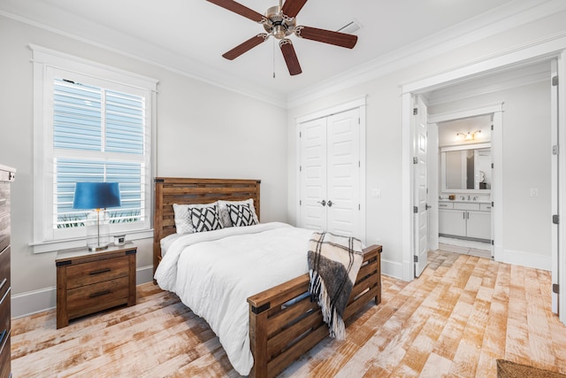 bedroom featuring crown molding, a closet, visible vents, light wood-style flooring, and baseboards