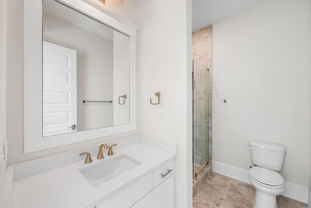 bathroom featuring baseboards, a shower stall, toilet, and vanity