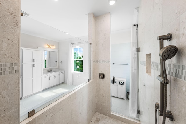 bathroom with tile walls, a tile shower, and vanity