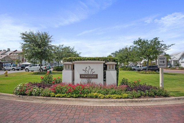 community / neighborhood sign with a lawn