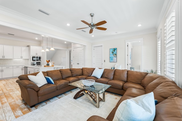 living area featuring recessed lighting, visible vents, crown molding, and light wood-style flooring