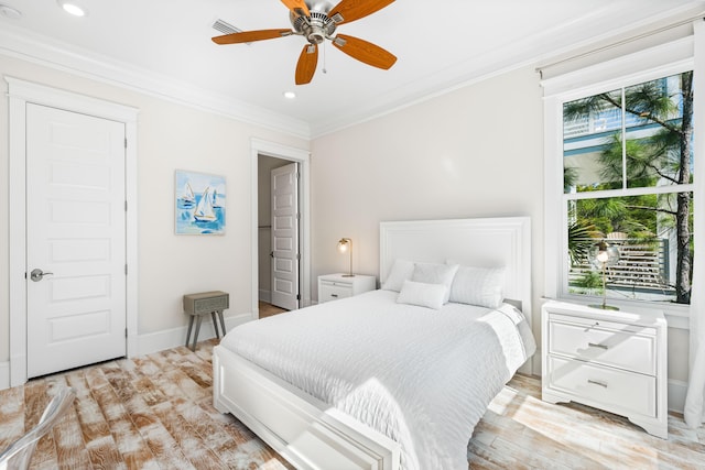 bedroom featuring recessed lighting, visible vents, baseboards, light wood finished floors, and crown molding