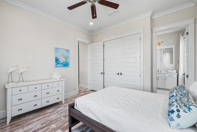 bedroom with baseboards, a closet, wood finished floors, and crown molding