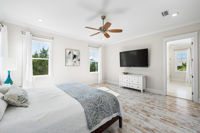 bedroom with visible vents, crown molding, and multiple windows