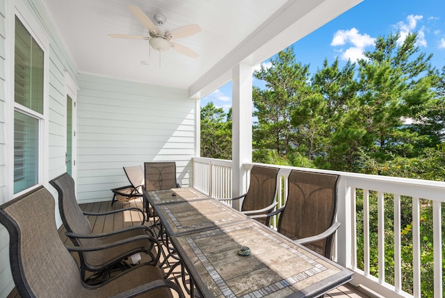 wooden terrace with a ceiling fan