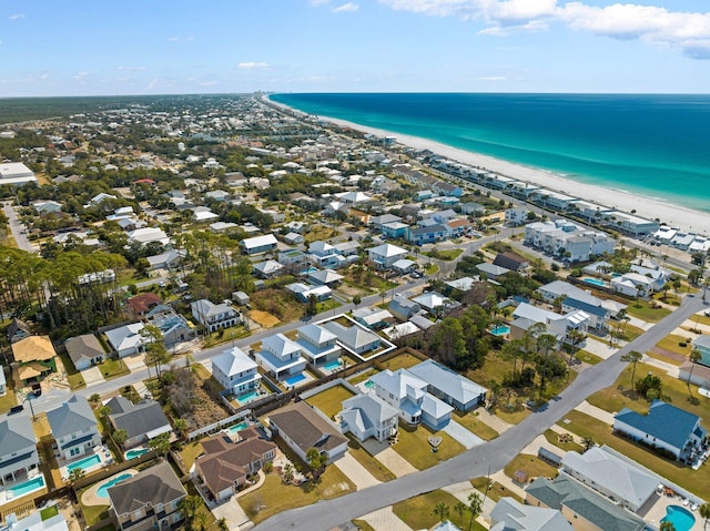 birds eye view of property with a beach view and a water view