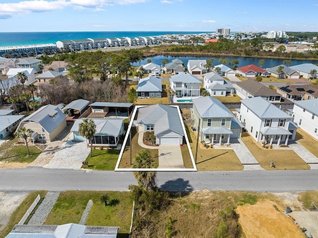 bird's eye view featuring a water view and a residential view