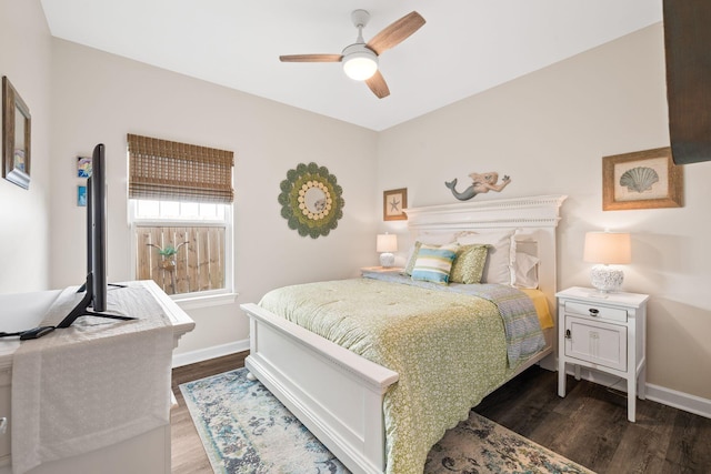 bedroom with a ceiling fan, dark wood finished floors, and baseboards