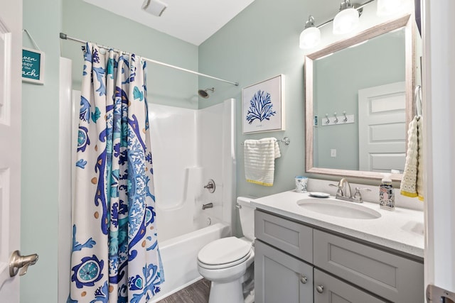 full bathroom featuring toilet, shower / bathtub combination with curtain, wood finished floors, and vanity