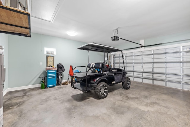 garage with baseboards and a garage door opener