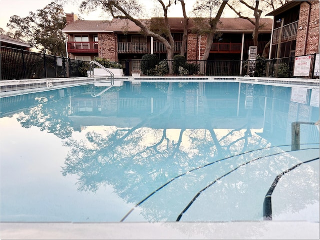 community pool featuring fence