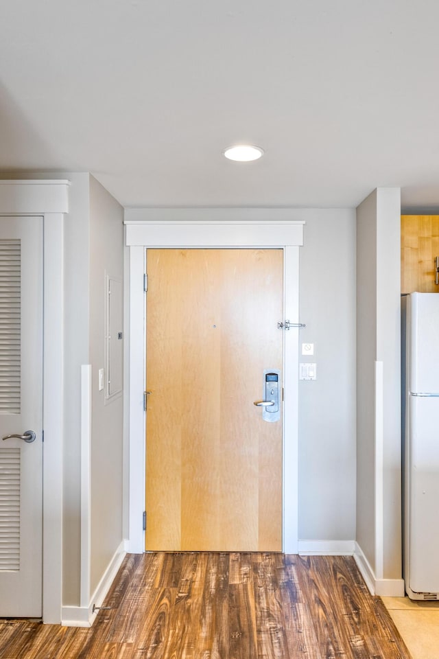 hallway with wood finished floors and baseboards