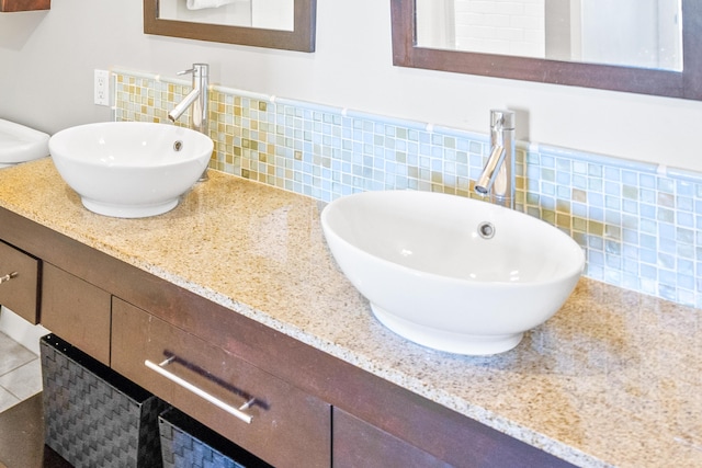 bathroom with tile walls, wainscoting, and vanity