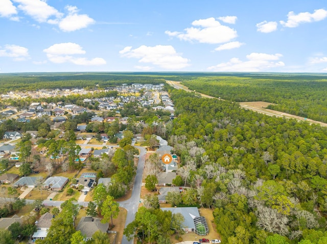 drone / aerial view with a forest view and a residential view